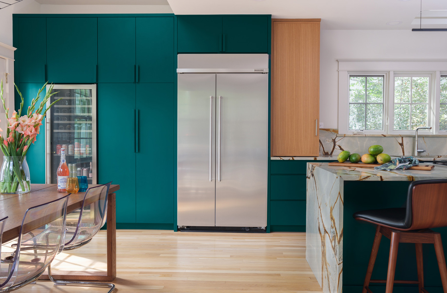 Modern kitchen with teal cabinetry and marble waterfall island in Webster Groves, Missouri — kitchen remodeling Hercules