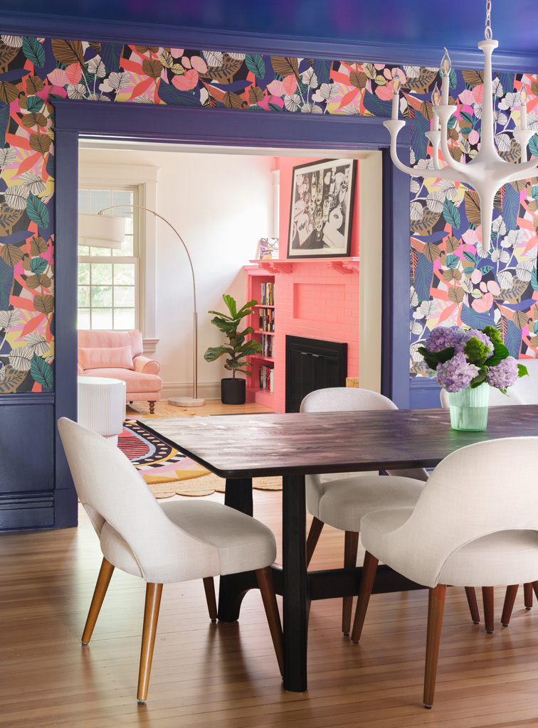 Dining room with bold floral wallpaper and modern white chairs in Webster Groves, Missouri — design build remodeling company St. Louis