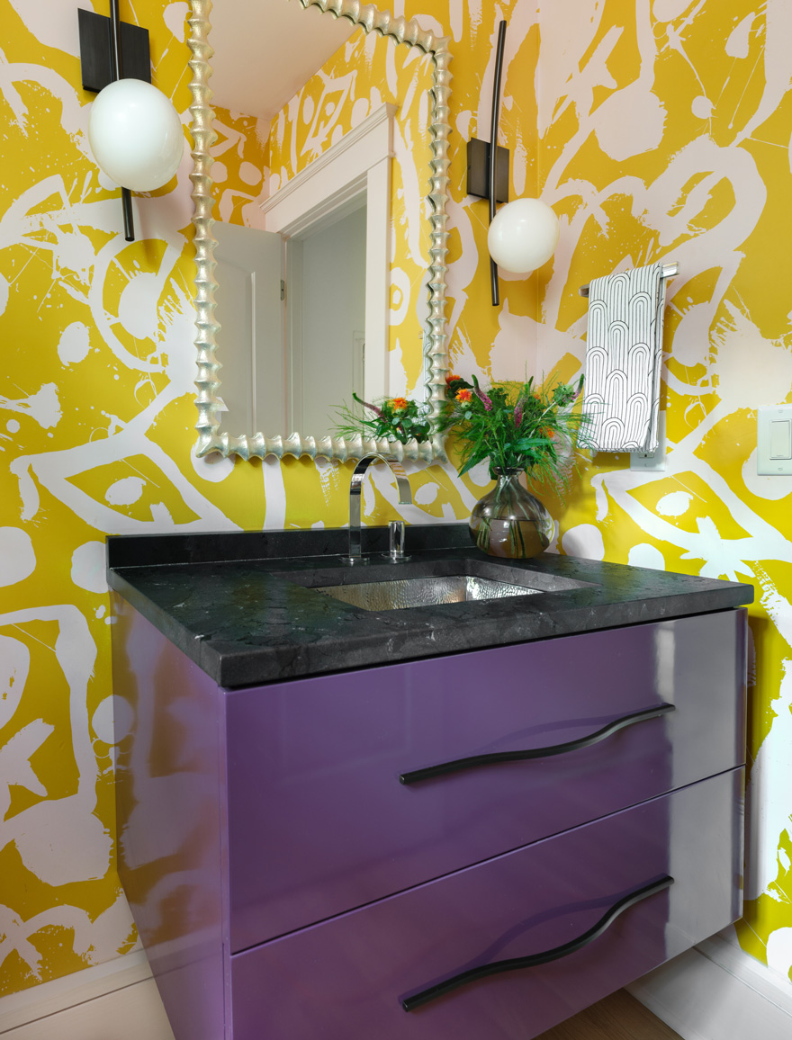 Powder room with bold yellow wallpaper and purple vanity in Webster Groves, Missouri — general contractor Hercules