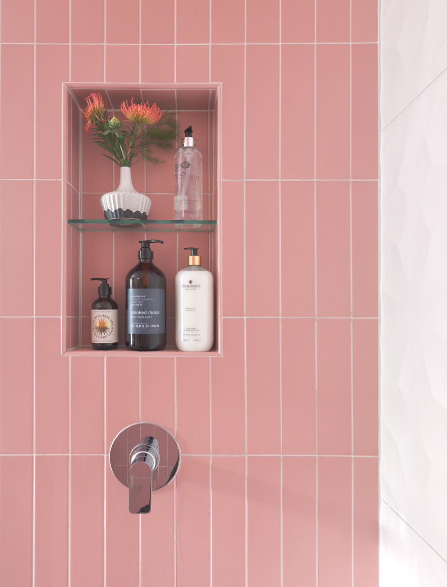 Pink tiled shower niche with built-in shelving in Webster Groves, Missouri — St. Louis design remodeling