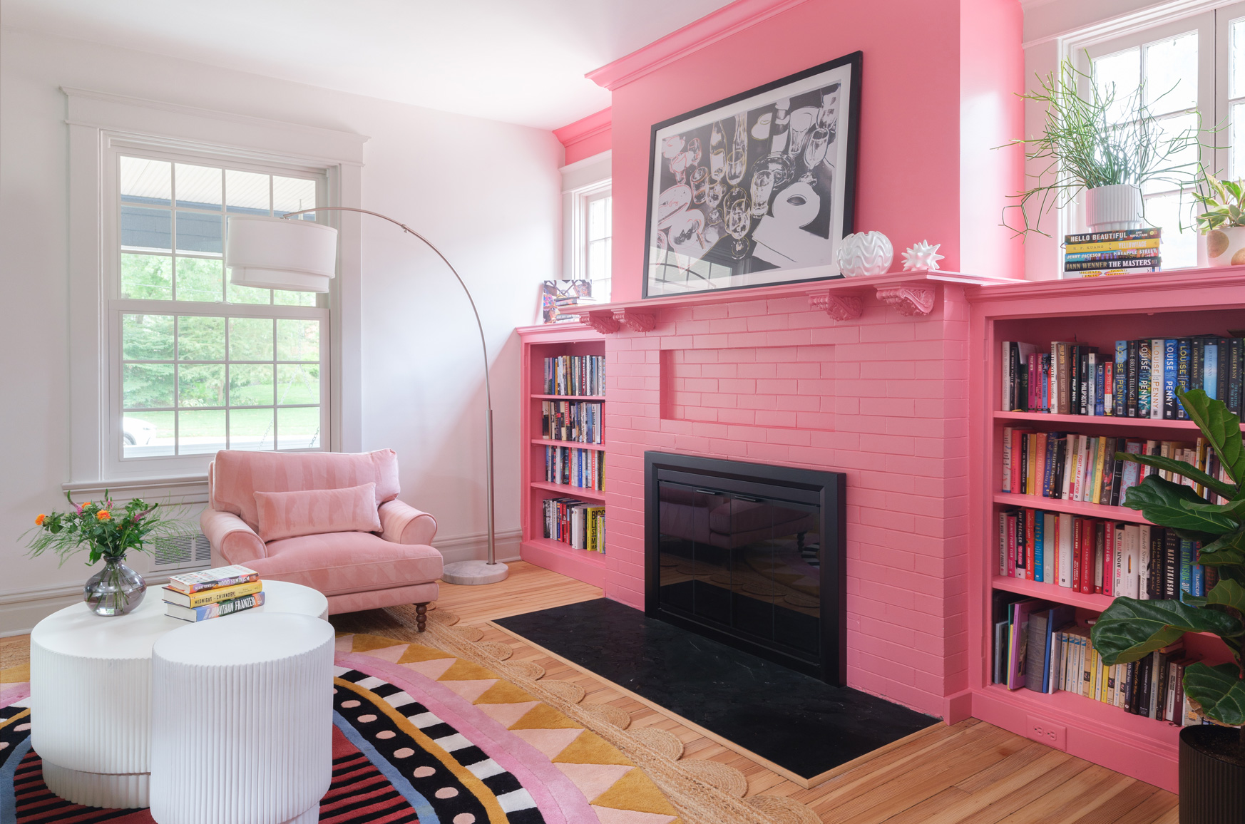 Living room with pink fireplace and built-in bookshelves in Webster Groves, Missouri — St. Louis design remodeling