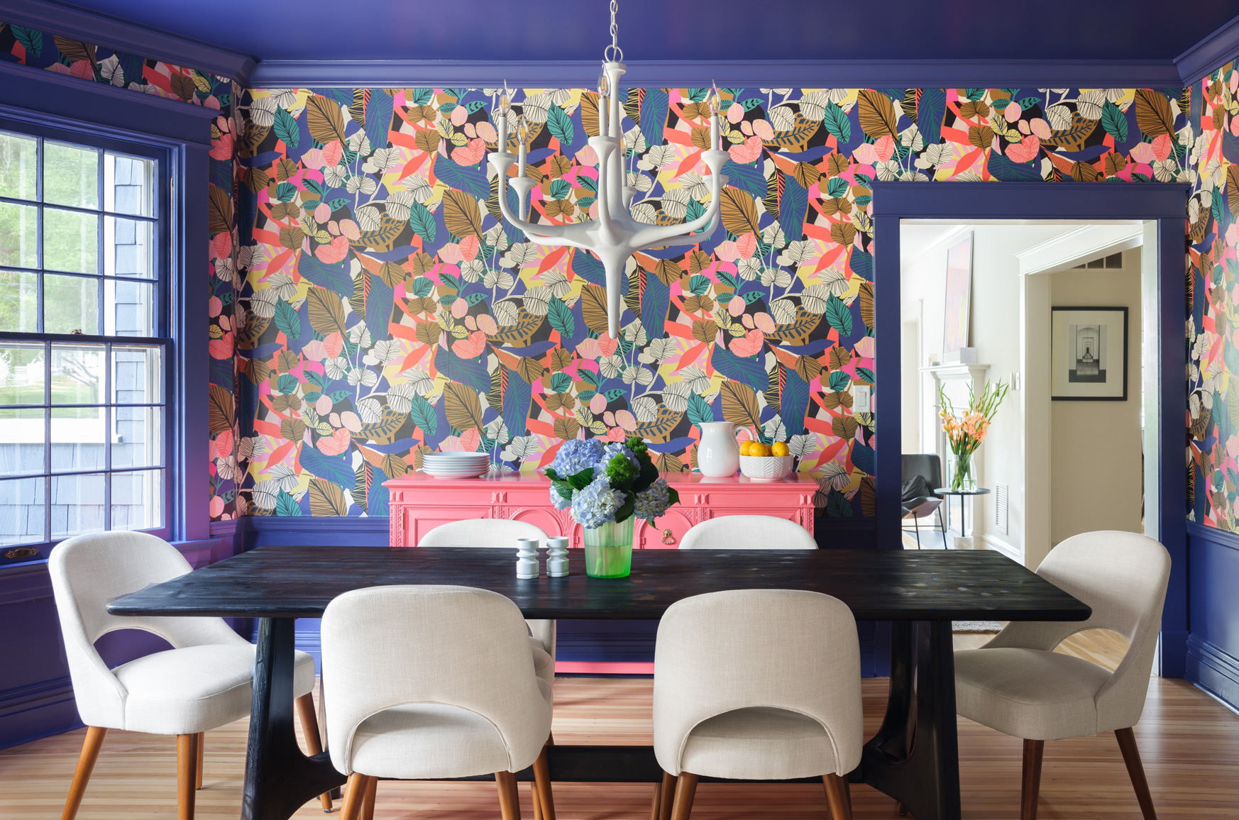 Dining room with colorful wallpaper and coral buffet in Webster Groves, Missouri — design build home remodeling company St. Louis