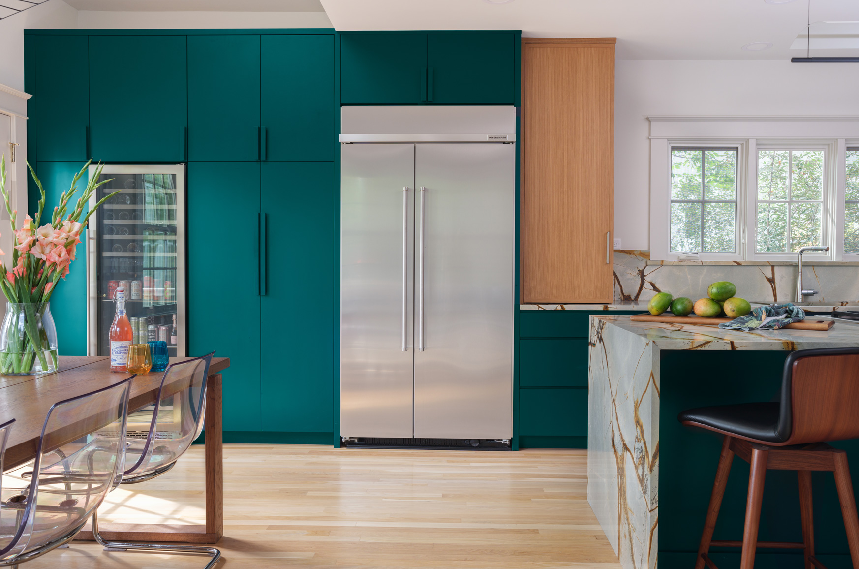 Modern kitchen with teal cabinetry and marble waterfall island in Webster Groves, Missouri — kitchen remodeling Hercules